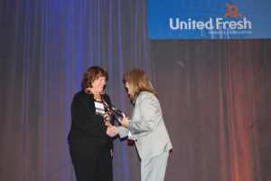 AVG editor Rosemary Gordon (right) presents the award to Maureen Torrey. 
