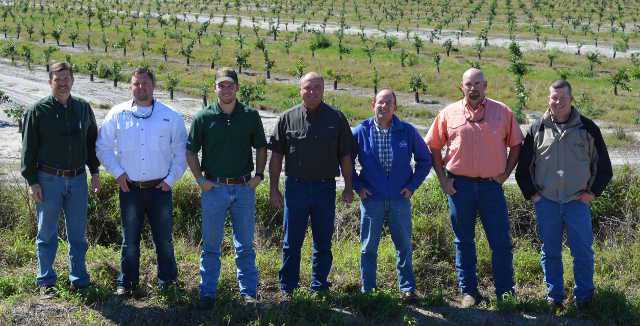 The Duda Citrus Division production team [from left] Joby Sherrod, Brad Dicks, Matt Reichenbach, Curtis Slade, Same Jones, Mike Martin, and Rob Atchley stand sin front of a large new block at its LaBelle grove. Photo by Frank Giles