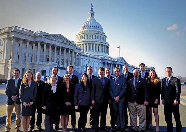 The 2014 Class of Young Apple Leaders pose front of the U.S. Capitol Building in Washington, DC, (from left) Glaize, Wittenbach, Burnham, Lott, Lerew, Brumback Liskey, Heinicke, Guzman, Hirsch, Holmberg, Poush, Alpers, Ferguson, Hardy, Johnston, Rudolph, and Rasch. Not pictured is Albinder. (Photo credit: U.S. Apple Association)