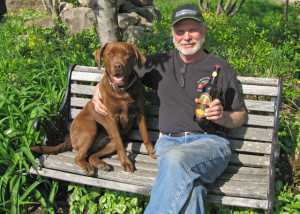 Jim Koan has been growing organic apples for approximately 20 years. He has expanded the orchard’s production with JK Scrumpy, a hard cider business that uses culls from the orchard. Koan is pictured with Bailey, who shows up on the JK Scrumpy Facebook page. (Photo credit: Monique Lapinski)
