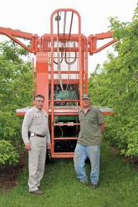Dan LaGasse (left) and Scott VanDeWalle (right) have worked together to create bin trailers, a hedger, a two-row planting plow, a wire-stringing attachment, and standard and over-the-row pruning platforms. (Photo Credit: Christina Herrick)