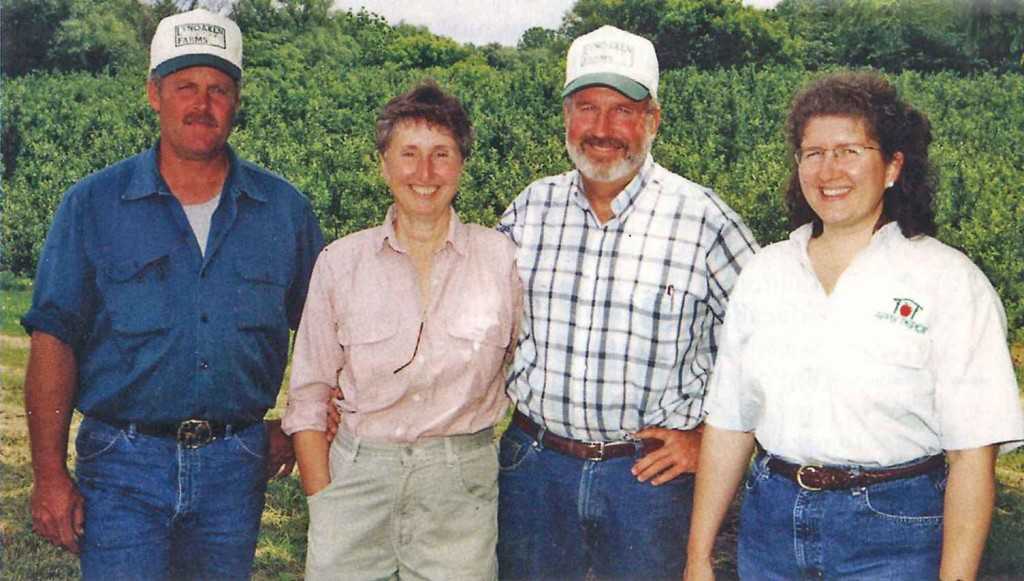 Darrel Oakes (third from left), American and Western Fruit Grower’s 2004 Apple Grower of the Year, is a co-owner at LynOaken Farms in Lyndonville, NY, along with, from left, his cousin Jeff Oakes, Darrel’s wife Linda, and his sister Wendy Wilson. (Photo Credit: Joe Ogrodnick)