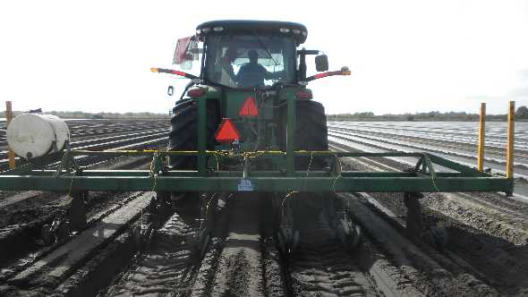 tractor rig applying fumigants in a vegetable field