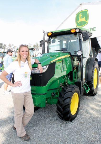 John Deere’s Lindsay Caes shows off  the 5100 GN is the most powerful in the 5G series, with a 100-horsepower engine.  (Photo credit: David Eddy)