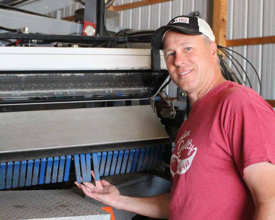 Jim Paarlberg of Paarlberg Farms points out how the Odenberg double sorters on his Pik Rite tomato harvester feature electronic fingers that can accept or reject tomatoes. Photo credit: Gabrielle Paarlberg