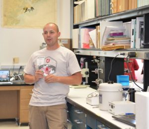 Brandon Hopkins, Washington State University entomology research associate, in the WSU Apiary Program lab he manages. (Photo credit: WSU) 