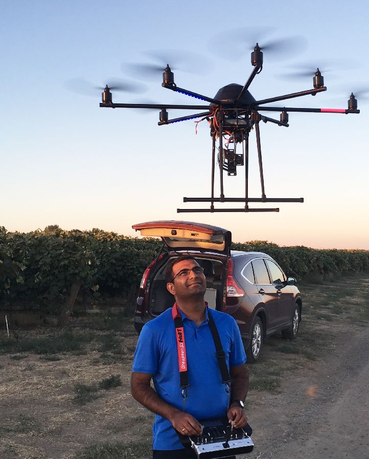 Washington State University Professor Lav Khot prepares to fly the 8-bladed octo-copter over a vineyard to measure how effectively a new irrigation method gets water to the vines. (Photo credit: WSU)