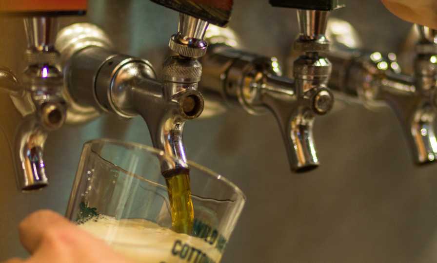 Craft beer tap flowing at Swamp Head Bre