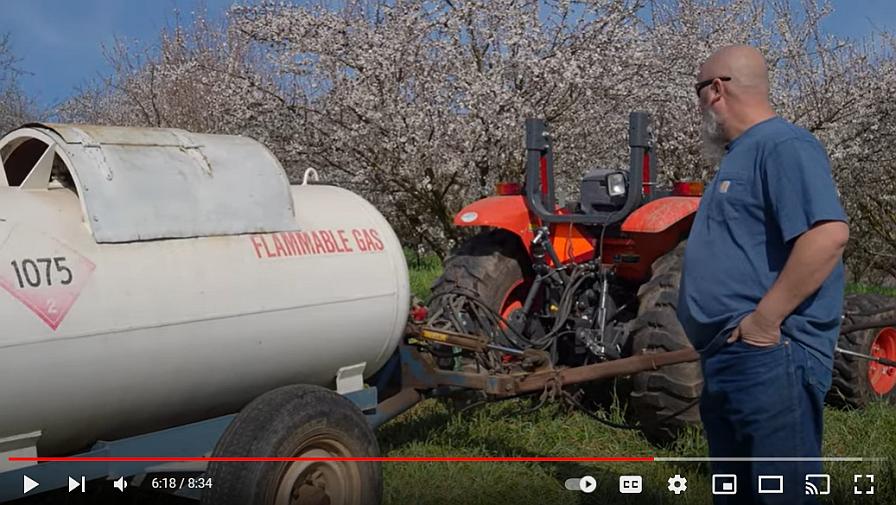 Screen capture of a flame weeder in the orchard at Burroughs Family Orchards in California