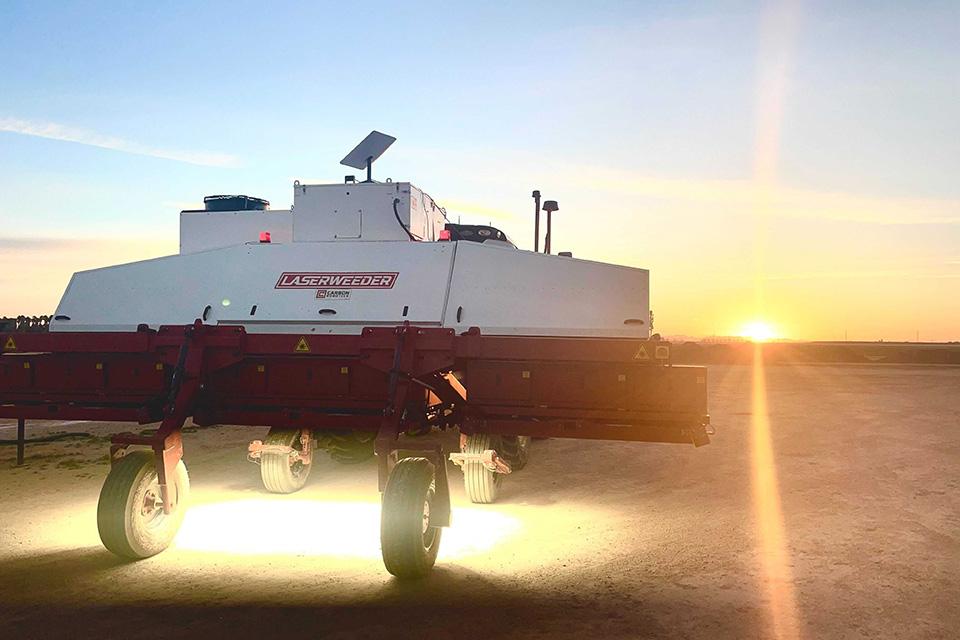 Laserweeder machine in the field at sunset